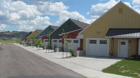 A row of units with garages and driveways.