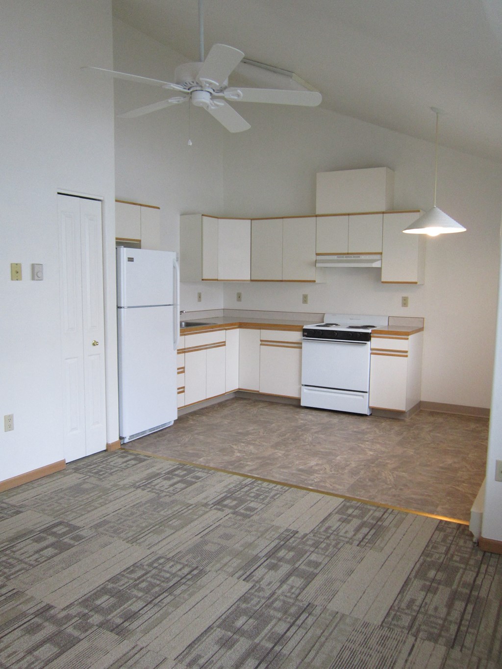 Image of Refrigerator, sink, cabinets, stove