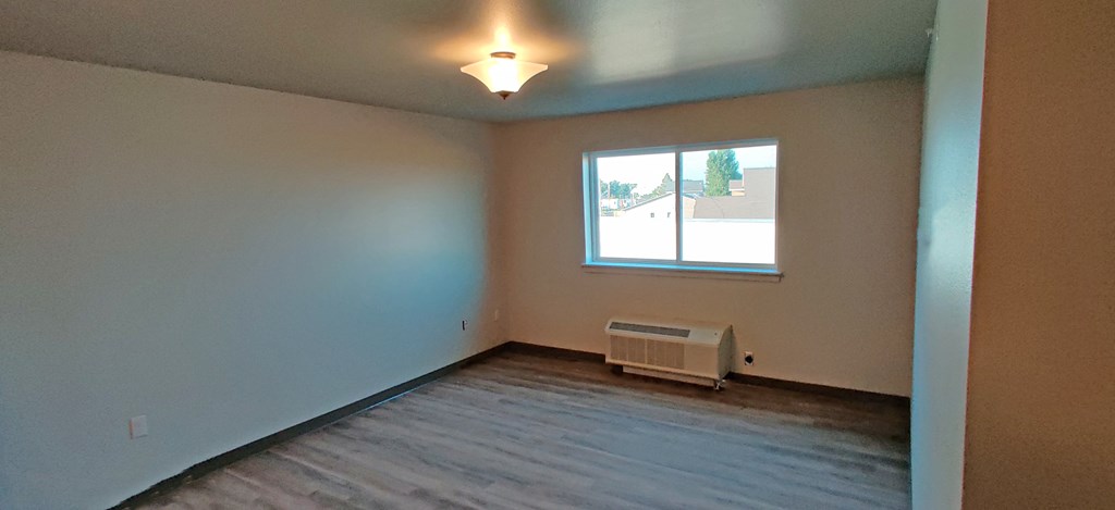 Image of an AC unit and a window in a bedroom