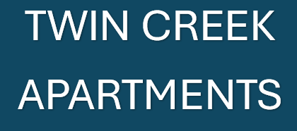 A sign that says Twin Creek Apartments.