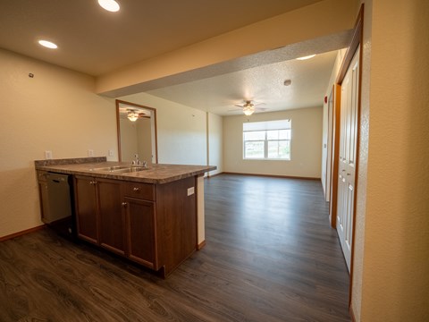 the view of a living room from the kitchen of an empty house