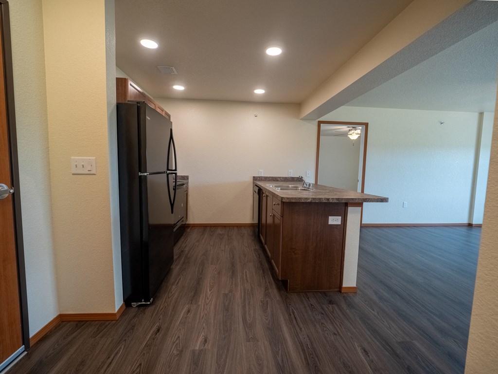 Image of refrigerator, stove, dishwasher, cabinets, and sink