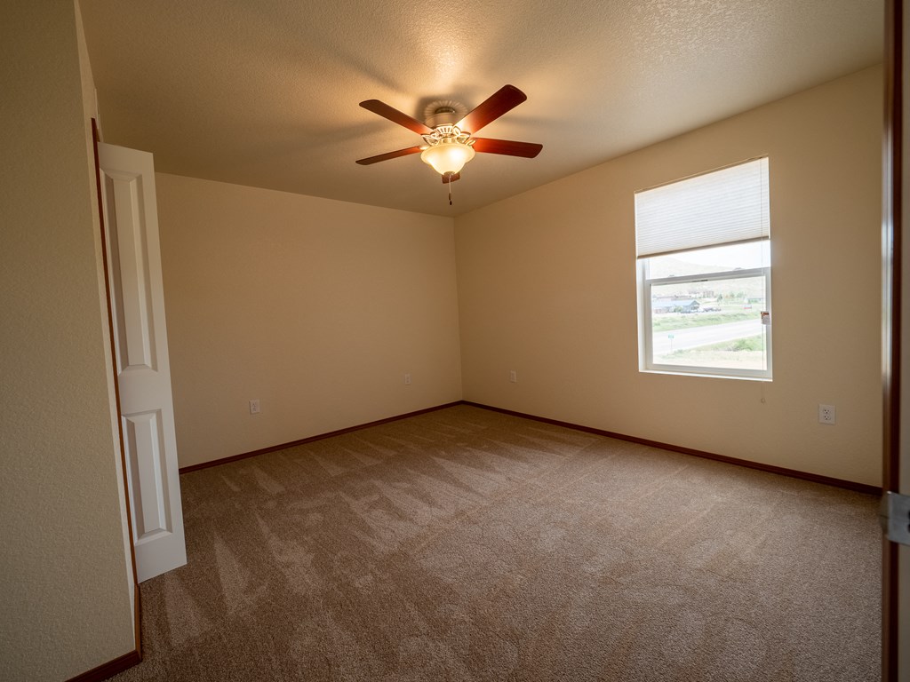 Image of bedroom with window, fan, and closet