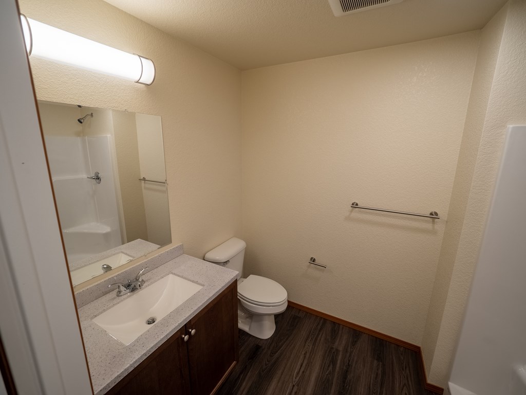 Image of bathroom sink, toilet, and mirror