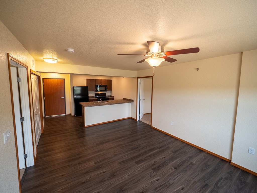 Image of kitchen layout with refrigerator, stove, microwave, and cabinets