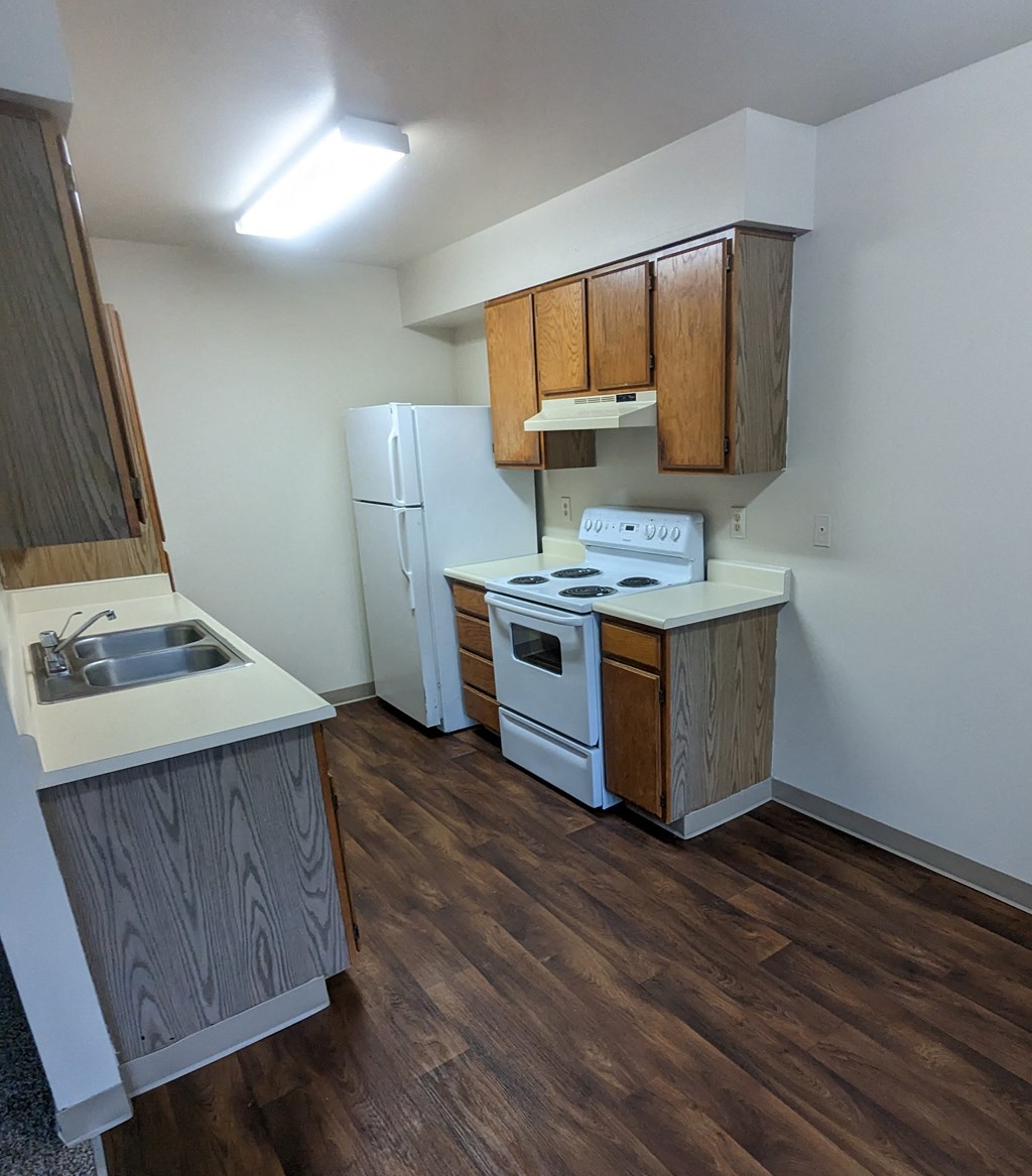Image of kitchen showing stove and refrigerator.