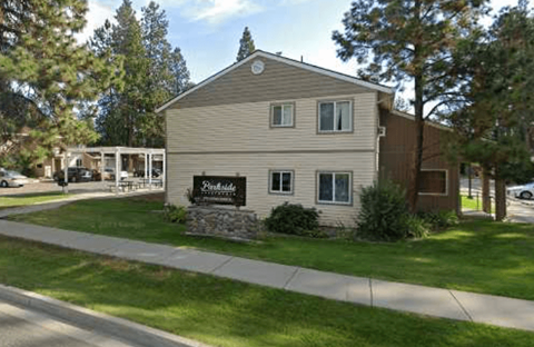 A building with a sign that says "Pinecrest" in front of it.