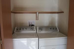 washer and dryer and shelf above