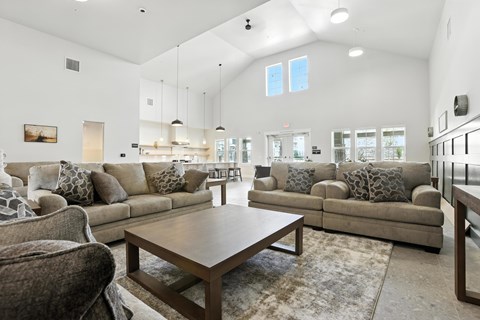A spacious living room with a large sectional sofa and a coffee table.