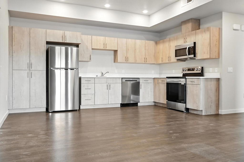 A modern kitchen with wooden cabinets and stainless steel appliances.