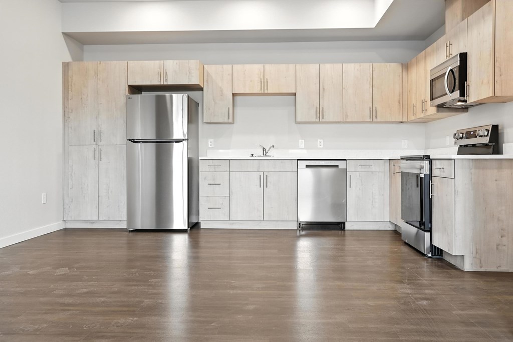 A kitchen with wooden cabinets and stainless steel appliances.
