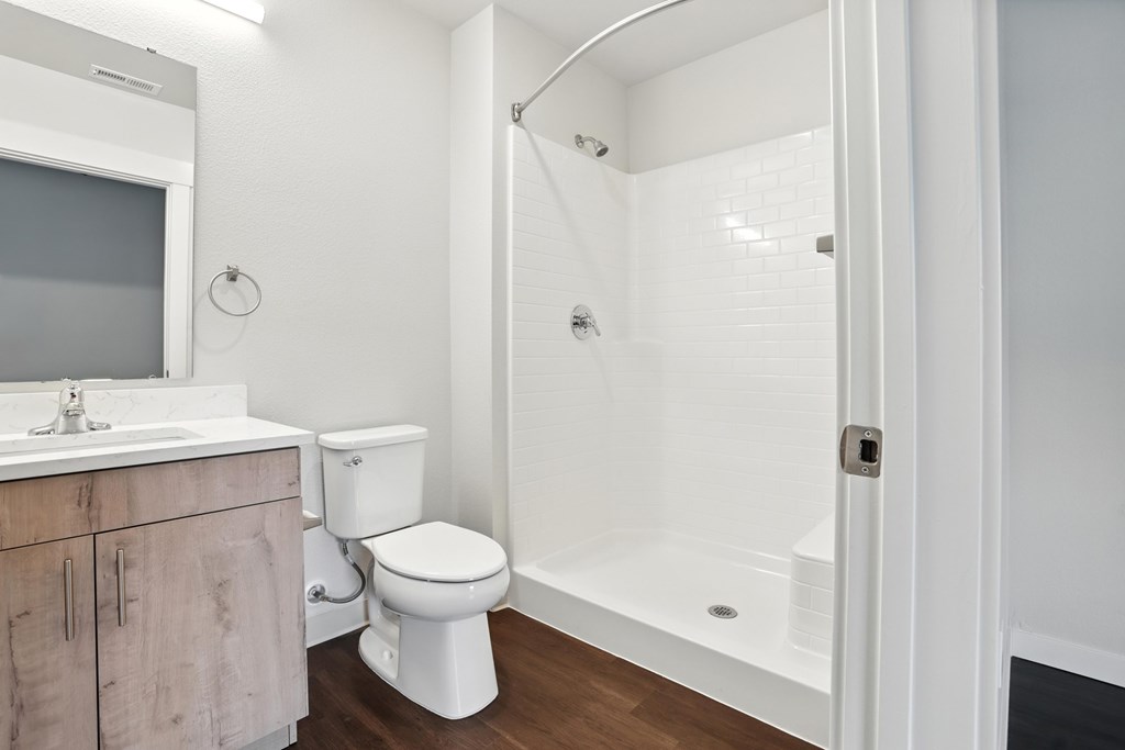 A white bathroom with a toilet, sink, and bathtub.