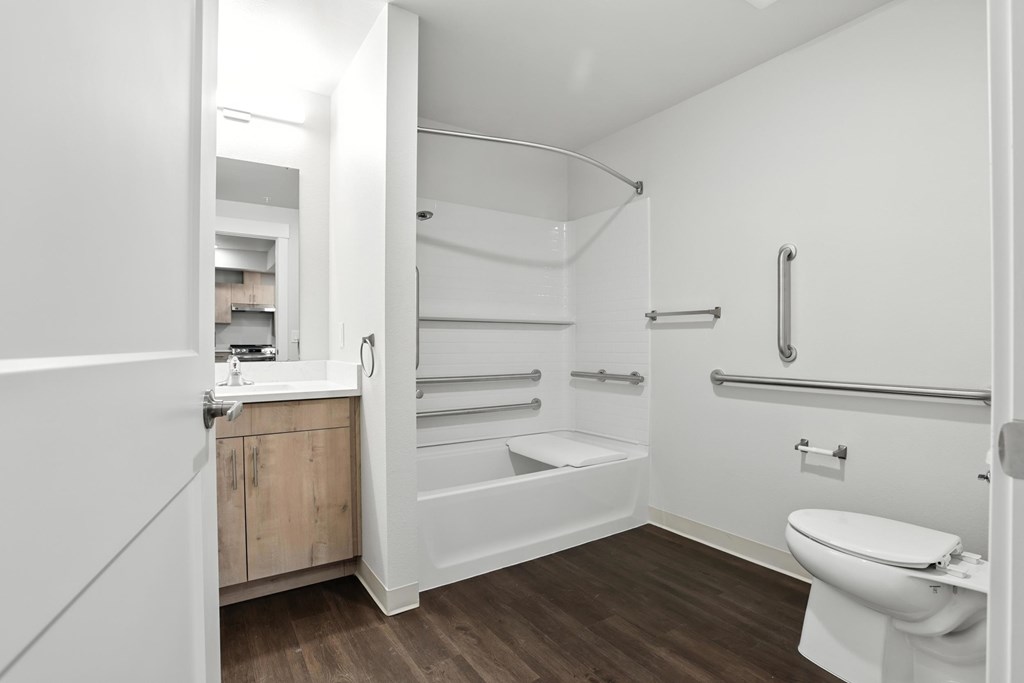 A white bathroom with a toilet, sink, and bathtub.