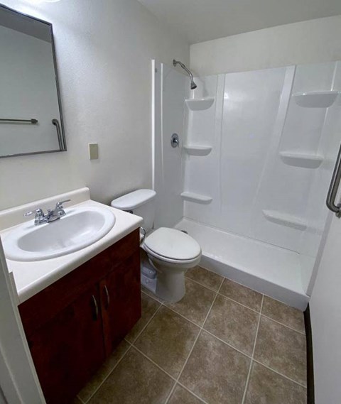 a bathroom with a sink toilet and a shower