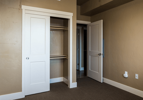 A white door is open to a hallway.