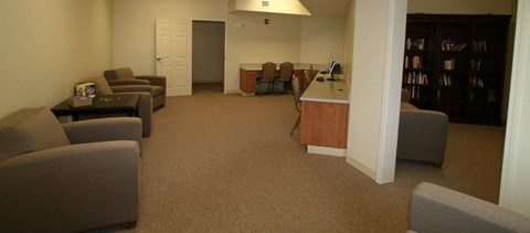 a living room with couches and chairs and a table