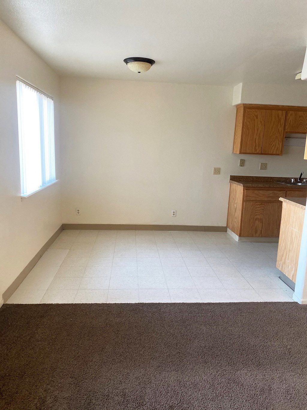 an empty kitchen and living room in a house