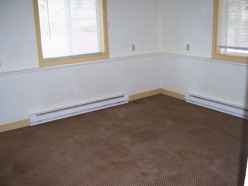 Room Image of space with two baseboard heaters and windows - Photo Gallery