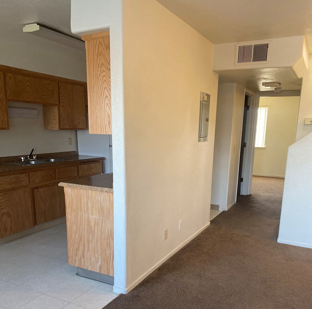 a view of a kitchen and a hallway in a house