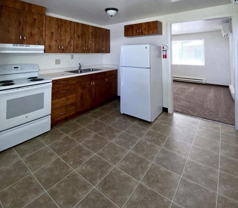 a kitchen with a stove refrigerator and sink