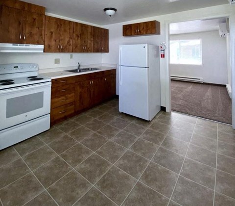 a kitchen with a stove and a refrigerator