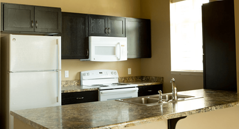 a kitchen with white appliances and granite counter tops