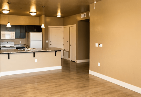 A kitchen with a white fridge and a white door.