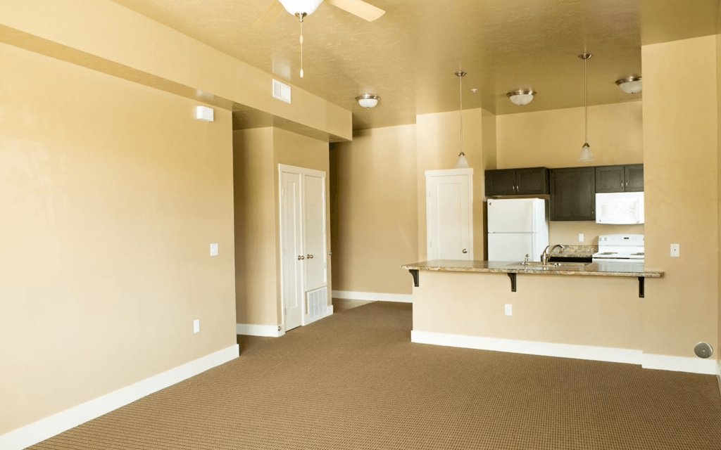 living room with a kitchen in the background