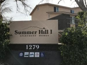 a sign for summer hill apartment homes in front of the property