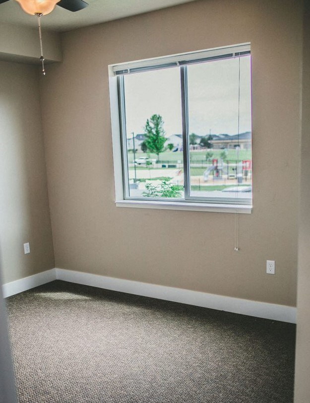 a large empty room with three windows