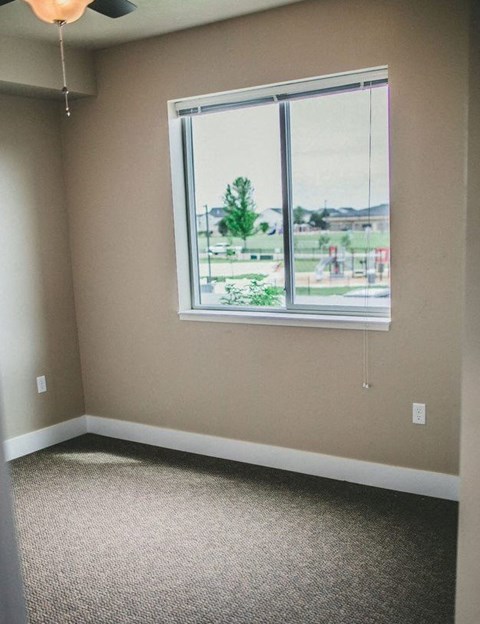 a room with a large window and a carpet