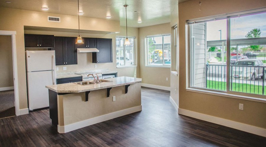 a kitchen with an island and a large window