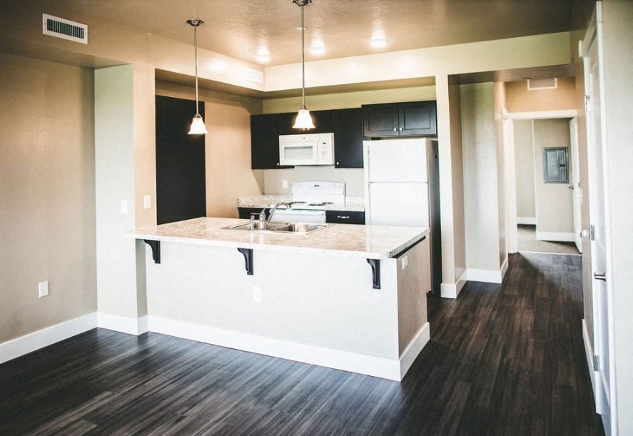 a kitchen with an island and a sink