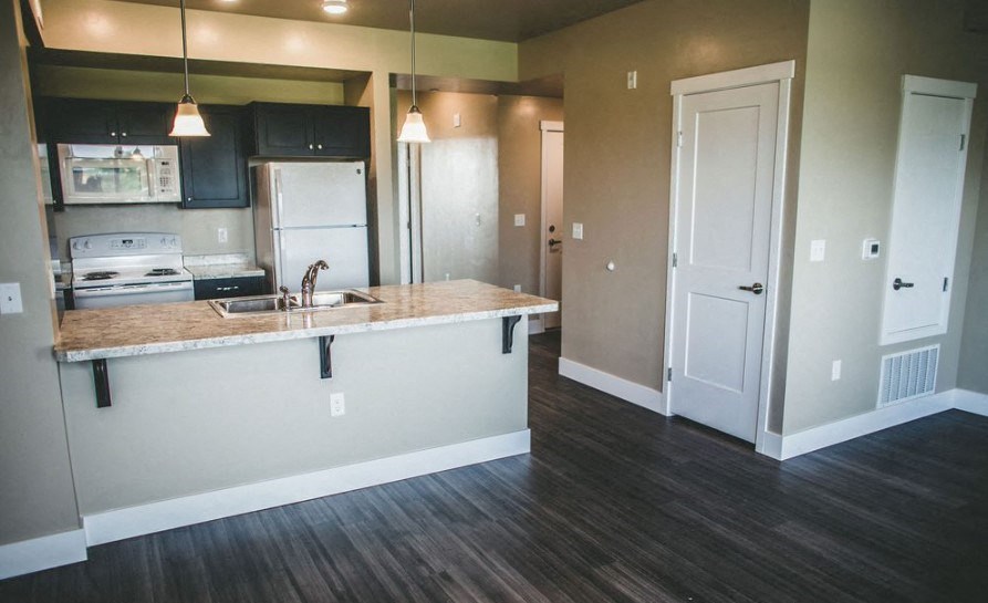 a kitchen with a counter and a sink and a refrigerator