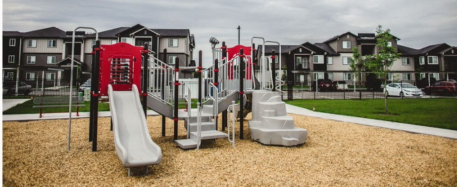 a playground in front of an apartment complex