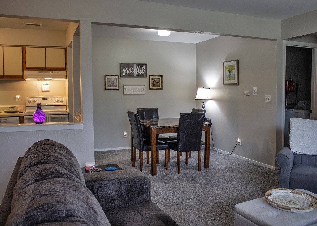 a living room and dining room with a couch and a table