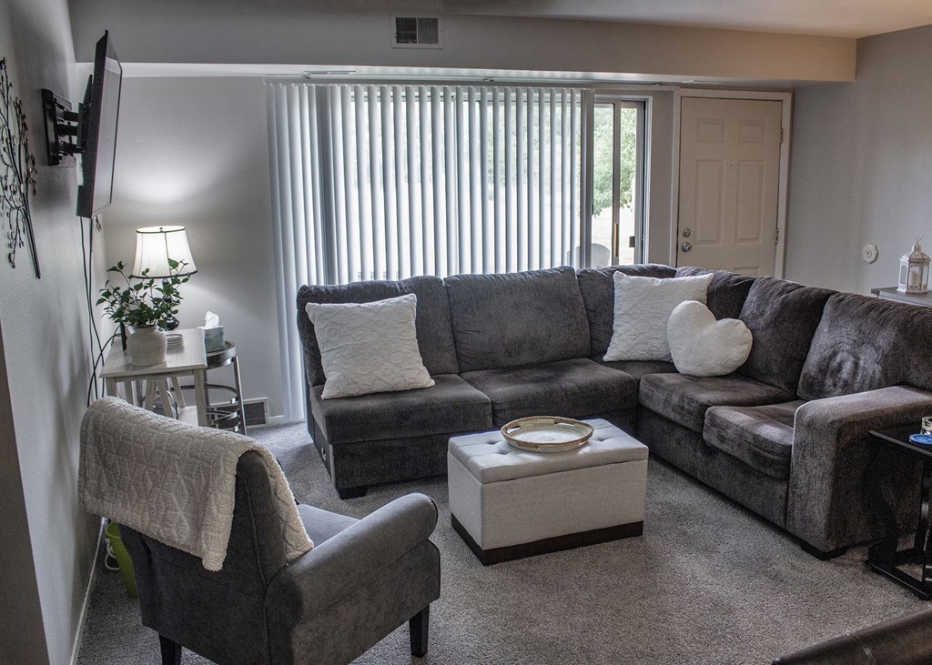 a living room with a couch and two chairs