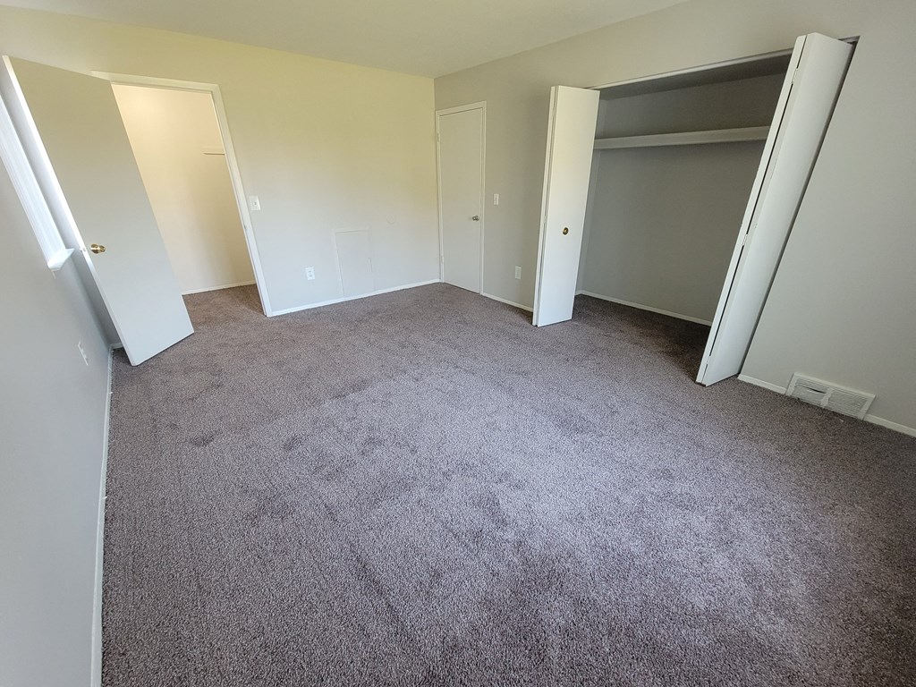 Spacious bedroom with large closet at Garfield Commons in Clinton Township, MI