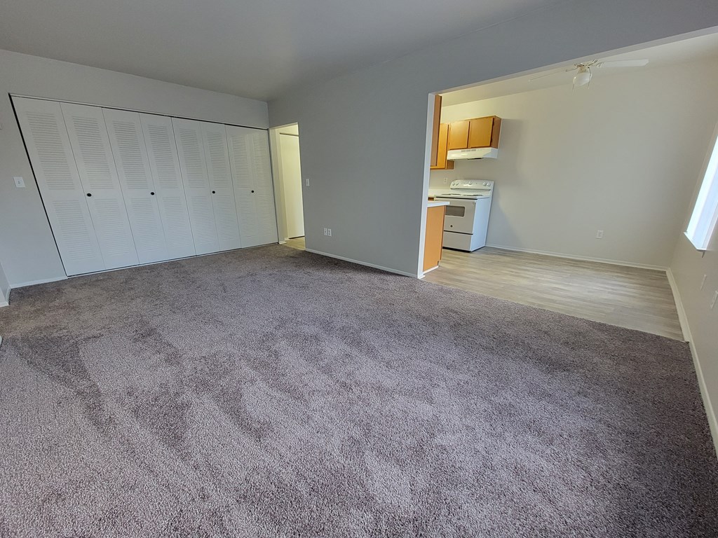 Spacious living room and dining room at Garfield Commons Apartments in Clinton Township, MI