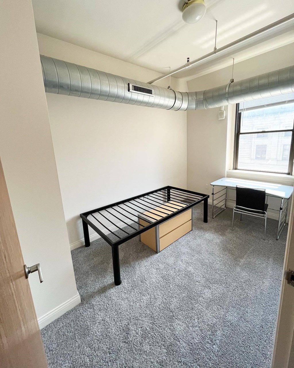 bedroom with bed frame at The Lofts at 5 Lyon, in downtown Grand Rapids, MI