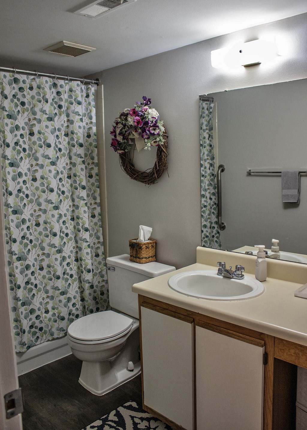 a bathroom with a shower curtain and a sink and a toilet