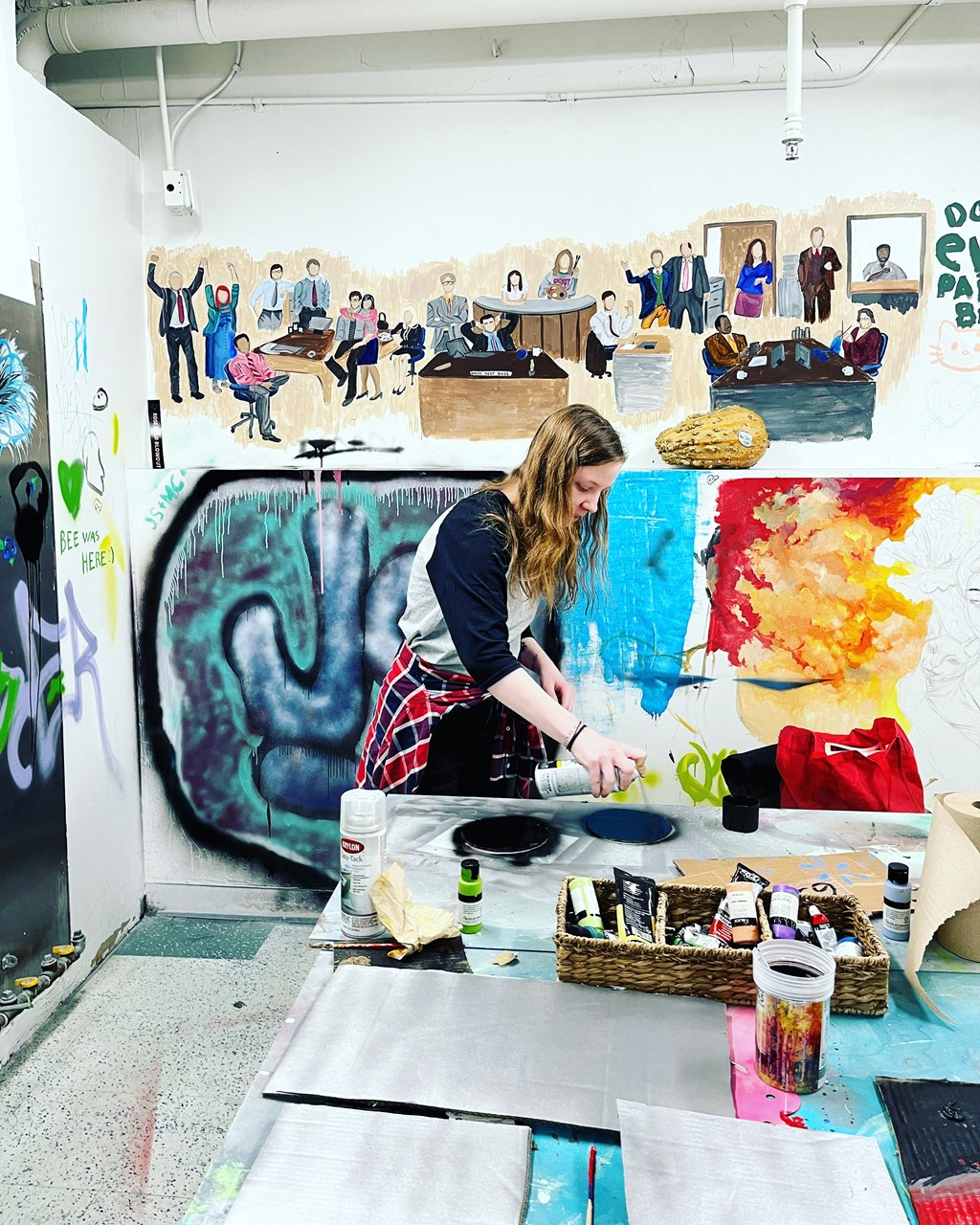 a woman painting in an art studio at The Lofts at 5 Lyon, in downtown Grand Rapids, MI