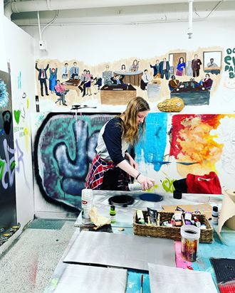 a woman painting in an art studio at The Lofts at 5 Lyon, in downtown Grand Rapids, MI - Photo Gallery