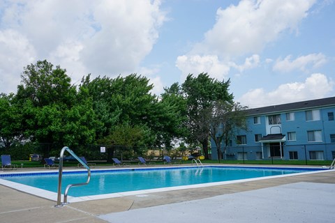 a swimming pool with a building in the background