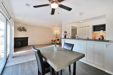 A dining room with a table and chairs.