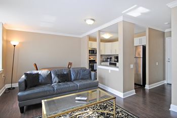 a living room with a couch and a glass coffee table