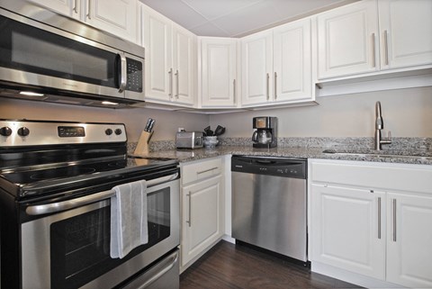 a kitchen with stainless steel appliances and white cabinets