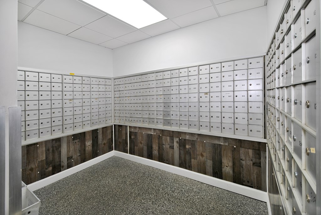 A room with a lot of mailboxes on the wall.