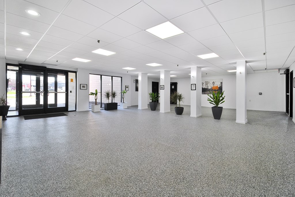 A spacious office with grey flooring and white walls.