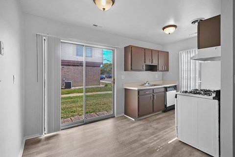 A kitchen with white cabinets and a white stove top oven.